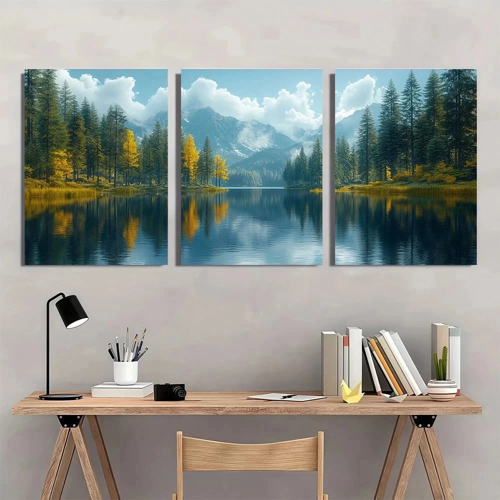Three-panel wall art of a mountain lake scene above a desk with books and a lamp.