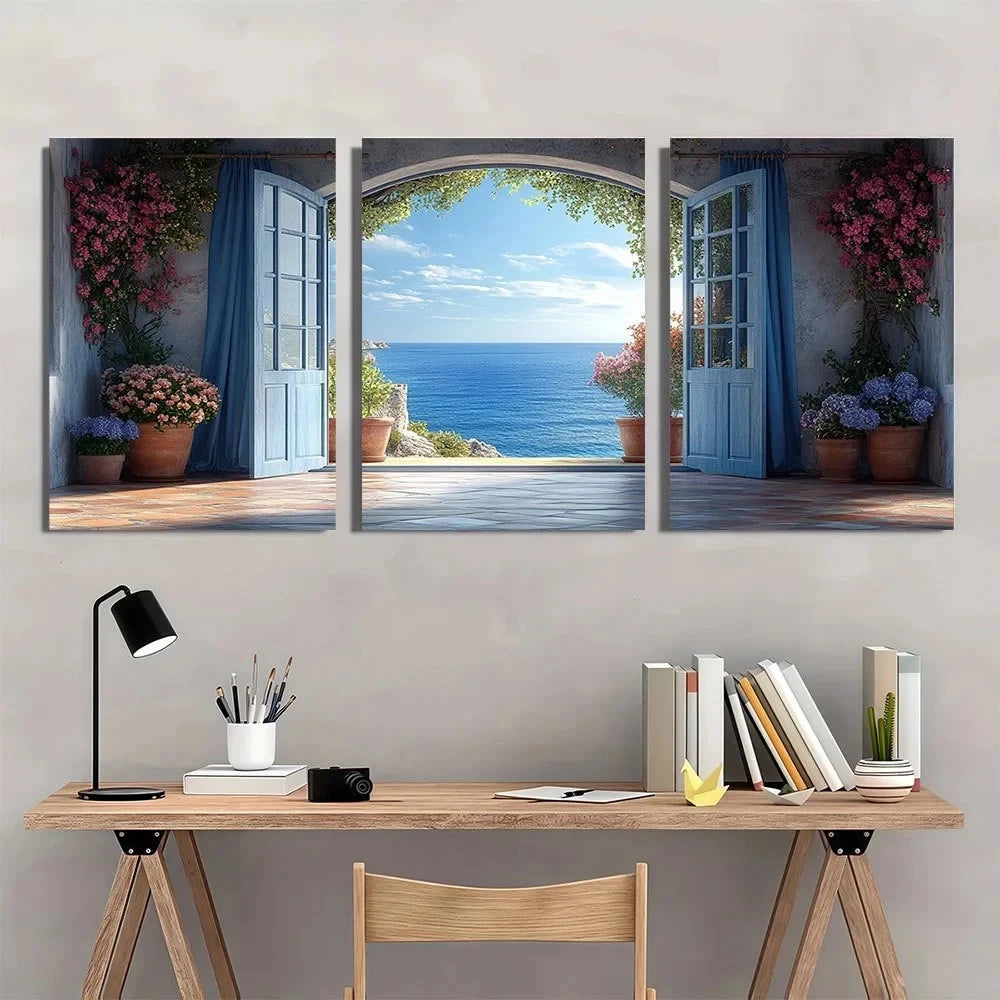 Three-panel wall art depicting a scenic view of the ocean with a desk and chair in front.