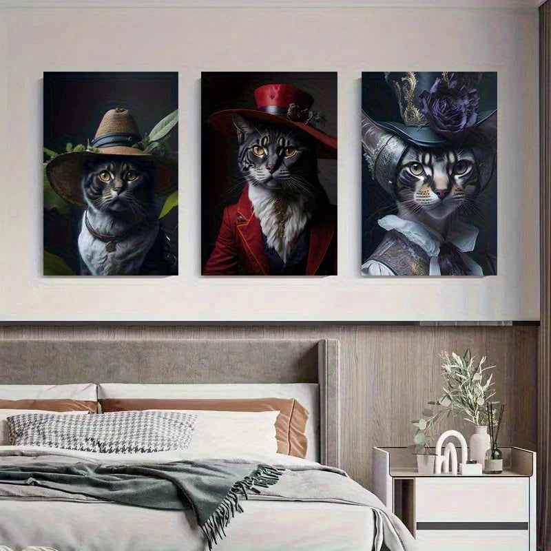 Three framed paintings of cats wearing hats on a wall above a bed.
