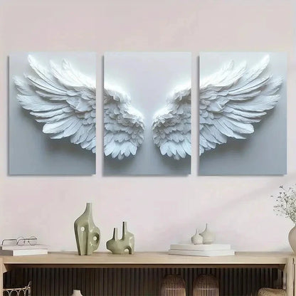 Three-panel wall art of white angel wings on a light pink wall above a wooden console table.