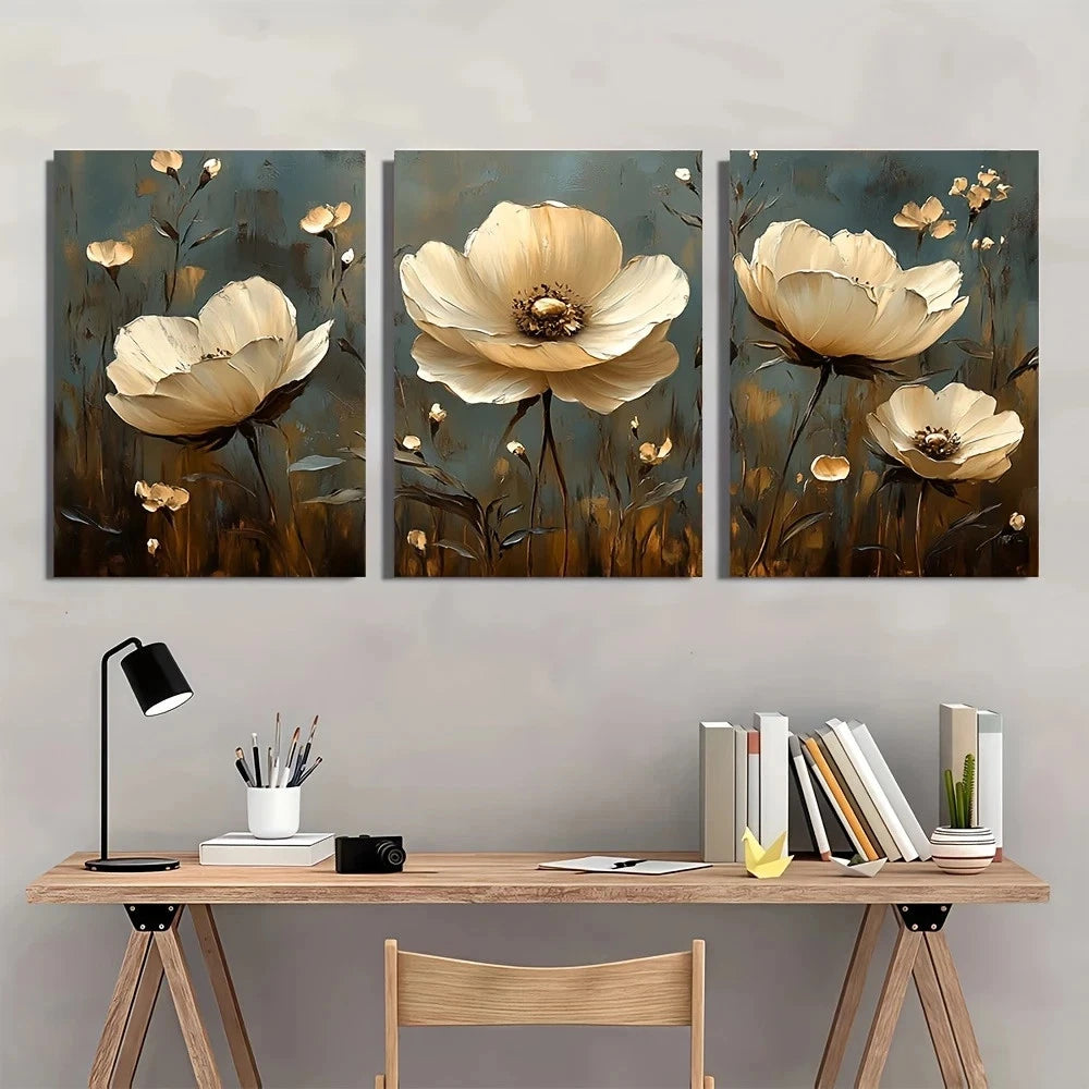 Three floral paintings above a desk with office supplies.