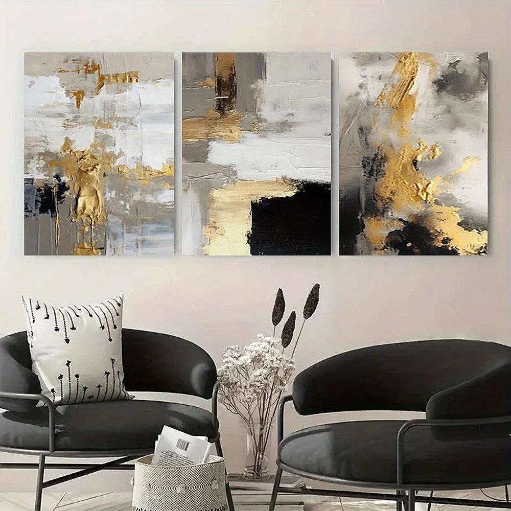 Abstract art triptych with gold and black accents above modern black chairs.