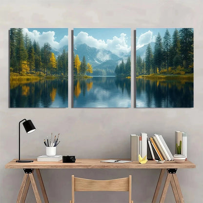 Three-panel wall art of a mountain lake scene above a desk with books and a lamp.