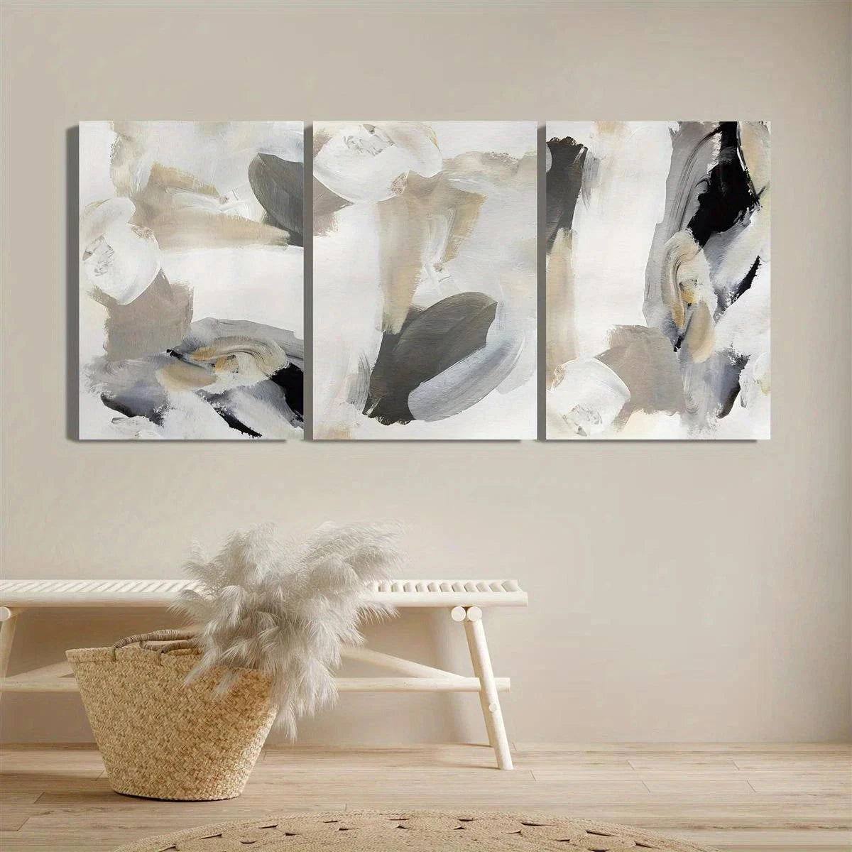 Abstract art triptych on a wall with a woven basket and decorative item below.