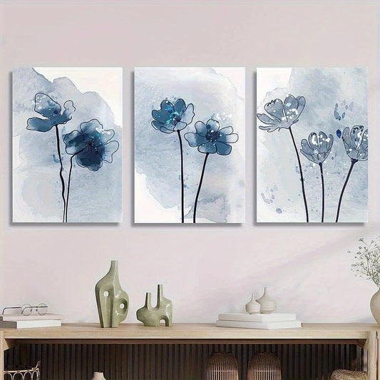 Three floral wall art pieces on a light pink wall above a wooden console table.