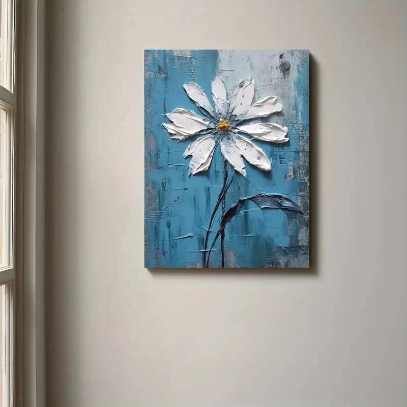 Painting of a white flower on a textured blue background hanging on a wall.