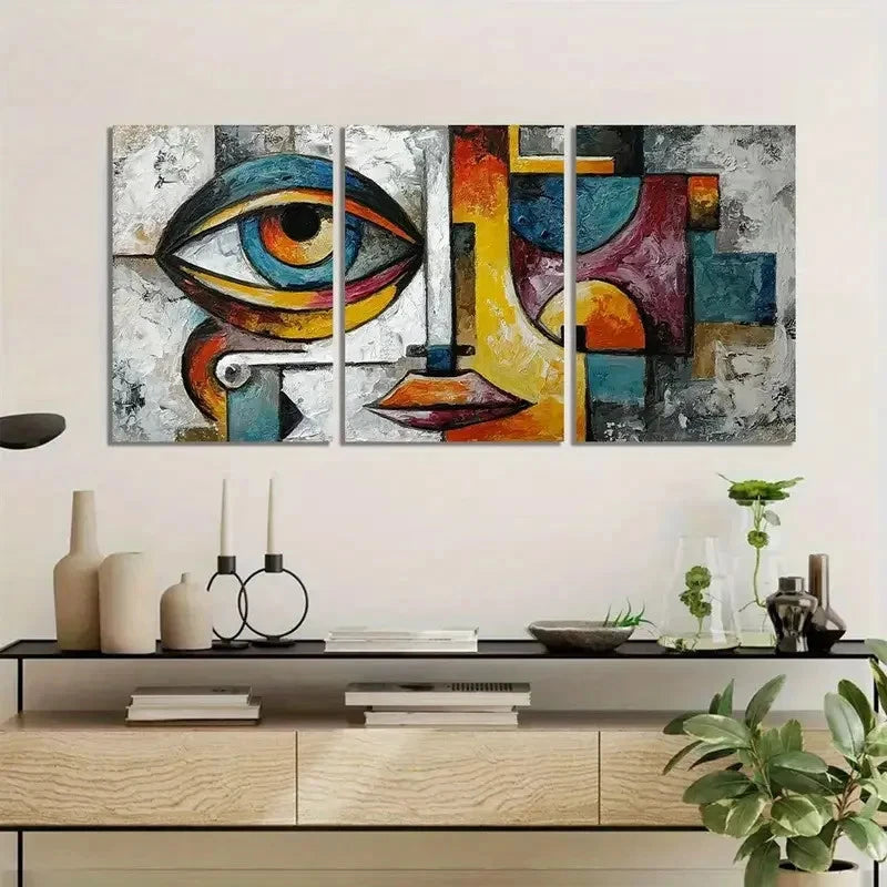 Abstract art triptych on a wall above a console table with decorative items.