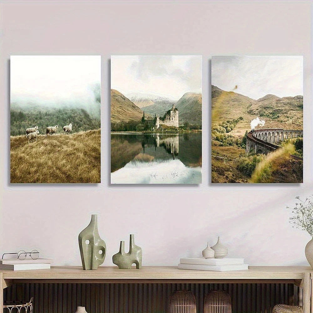 Three landscape paintings of a castle, mountains, and a bridge on a wall above a wooden console table.