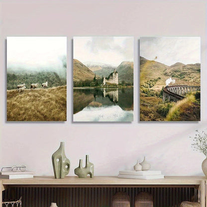 Three landscape paintings of a castle, mountains, and a bridge on a wall above a wooden console table.