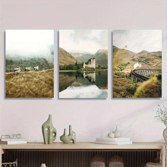 Three landscape paintings of a castle, mountains, and a bridge on a wall above a wooden console table.