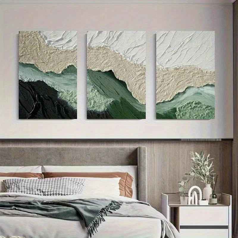 Three abstract wall art pieces above a bed in a bedroom setting.