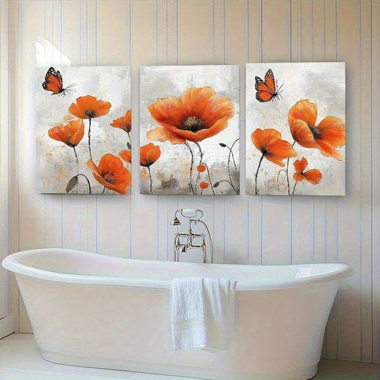 Three-panel wall art of orange flowers and butterflies above a white freestanding bathtub.
