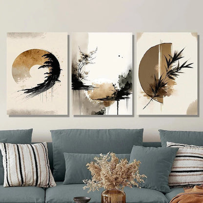 Three abstract art pieces on a wall above a sofa with decorative pillows and a vase.