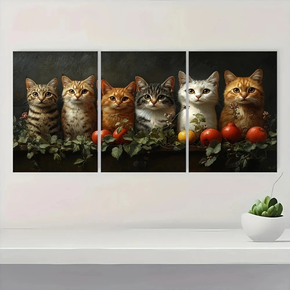 Three-panel artwork of cats with fruits on a white wall above a shelf with a plant.