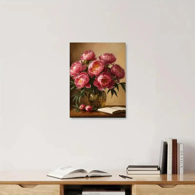 Framed artwork of pink flowers on a wall above a shelf with books.