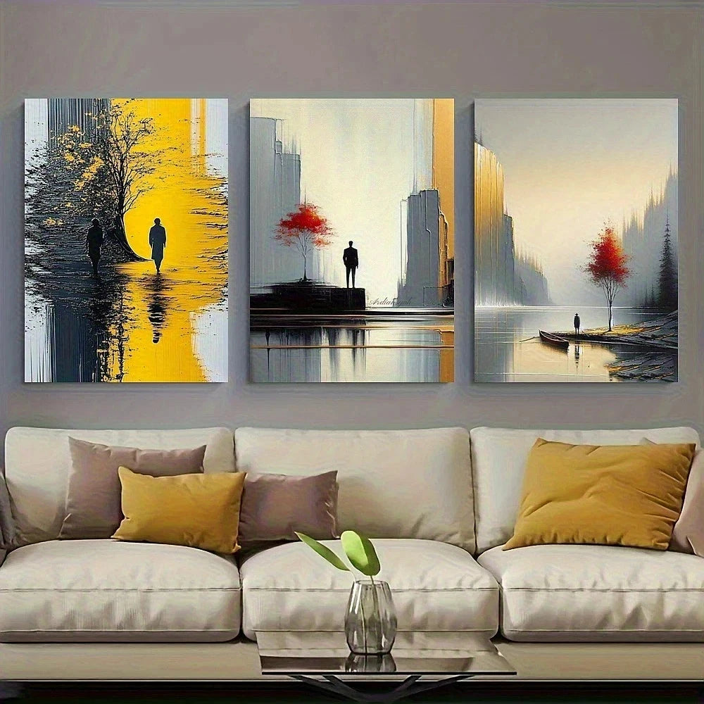 Three abstract paintings on a wall above a beige sofa with decorative pillows.