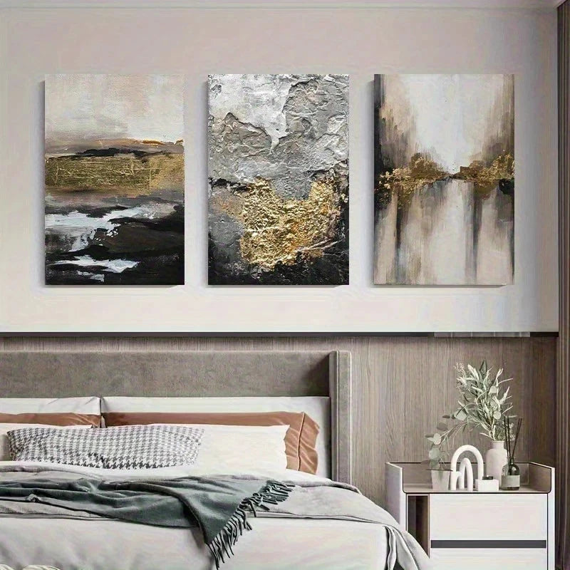 Three abstract paintings above a bed in a bedroom setting.