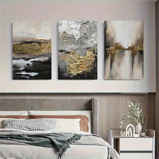 Three abstract paintings above a bed in a bedroom setting.