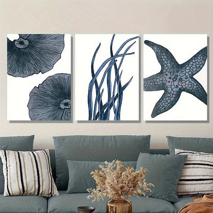 Set of three framed artworks with blue floral and starfish designs on a wall above a sofa.