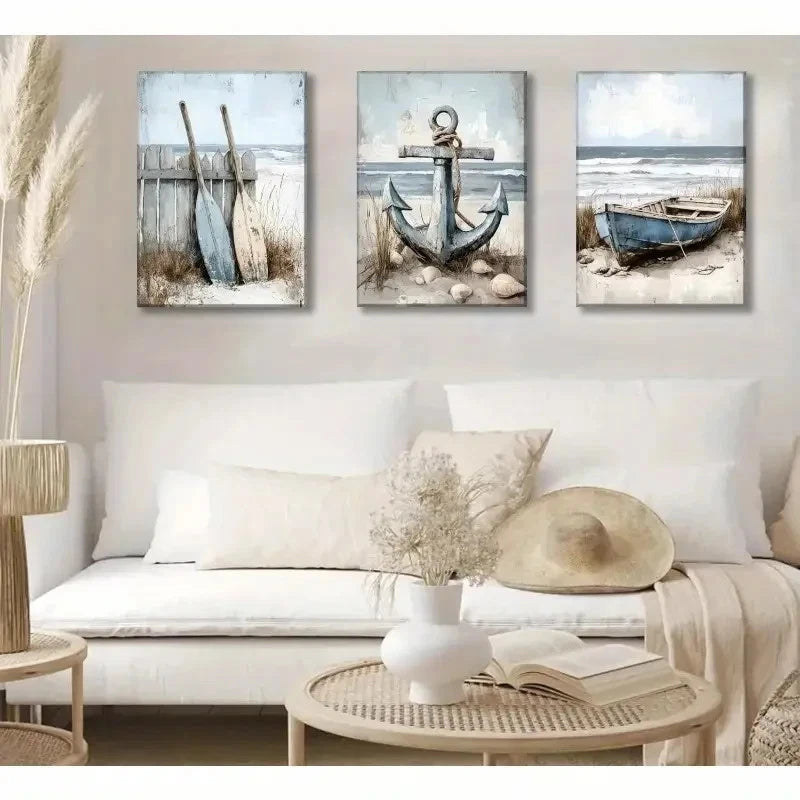 Three coastal-themed wall art pieces above a white sofa in a living room.
