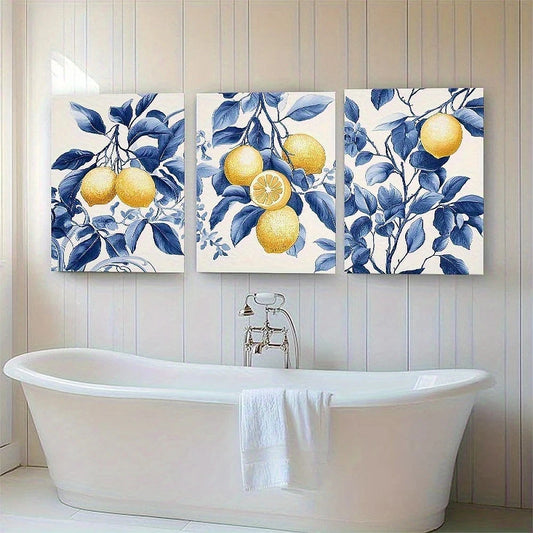 Three canvas prints with lemon and leaf designs above a white bathtub.