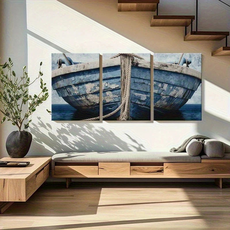 Modern living room with a large wall art of a blue boat and a plant on a wooden side table.