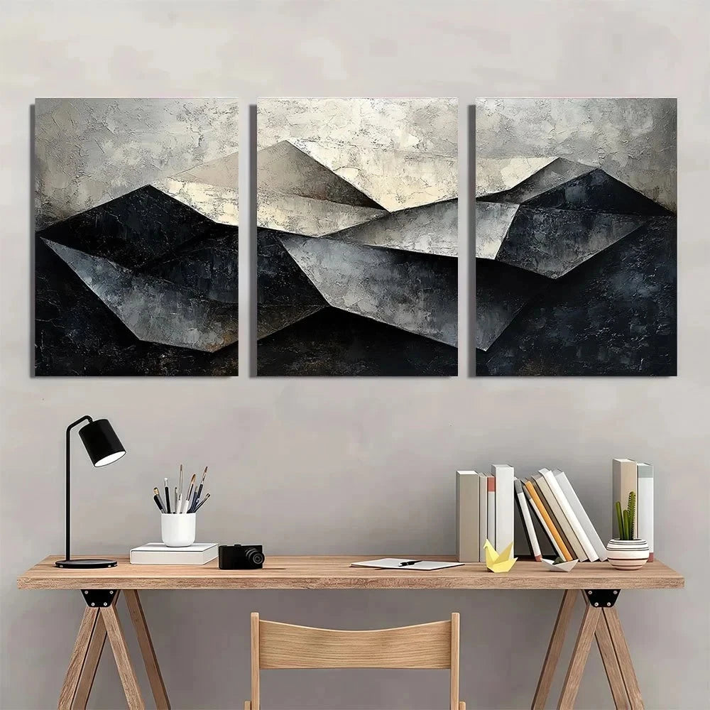 Three-panel abstract mountain painting above a wooden desk with office supplies.