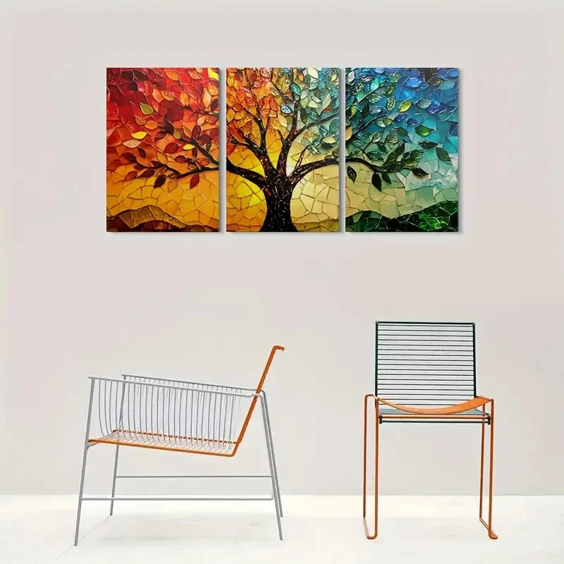 Triptych wall art of a colorful tree on a white wall with two modern chairs below.