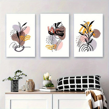 Three abstract art prints on a wall above a console table with decorative items.