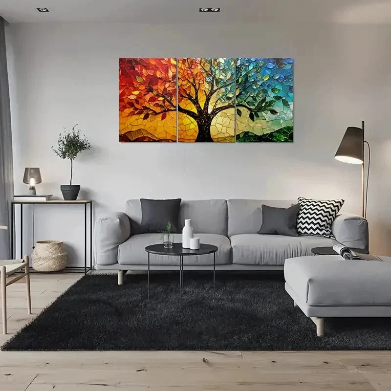Modern living room with a gray sectional sofa, black rug, and colorful abstract wall art.