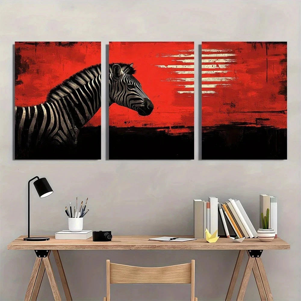 Three-panel wall art of a zebra on a red background above a desk with books and stationery.