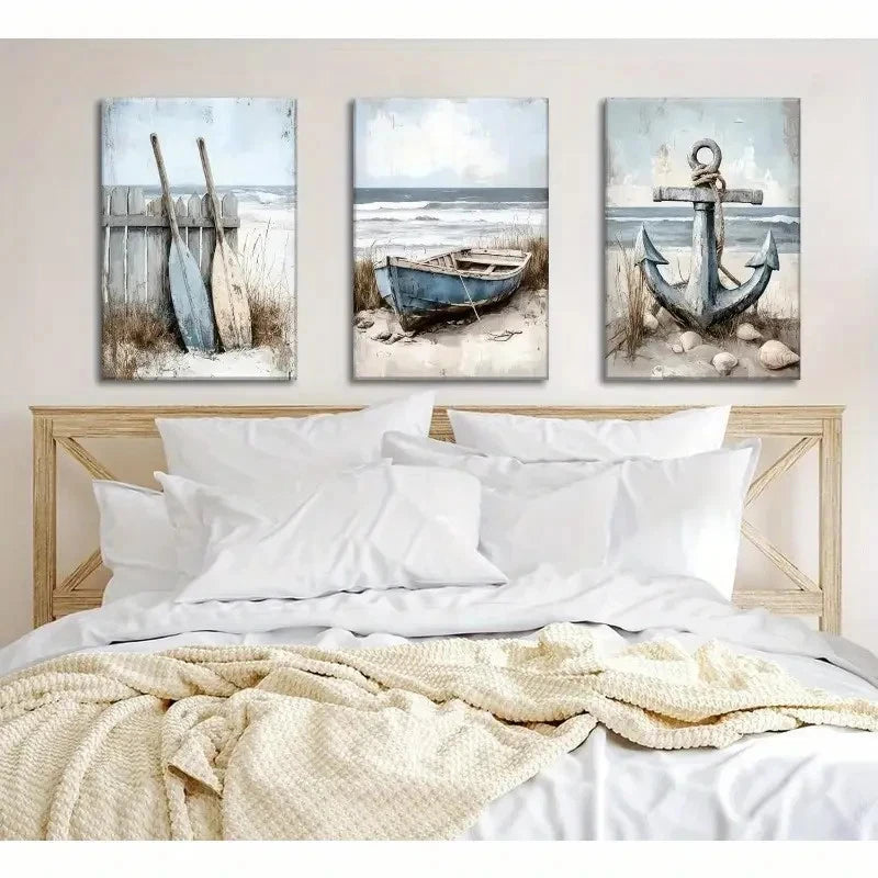 Three beach-themed wall art pieces above a bed with white bedding and beige blanket.