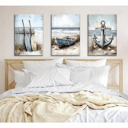 Three coastal-themed wall art pieces above a bed with white bedding.