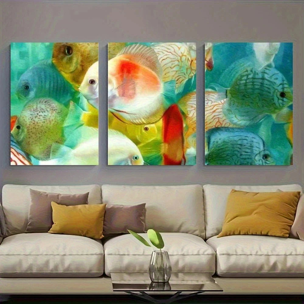 Three colorful fish paintings on a wall above a beige sofa with yellow and brown cushions.