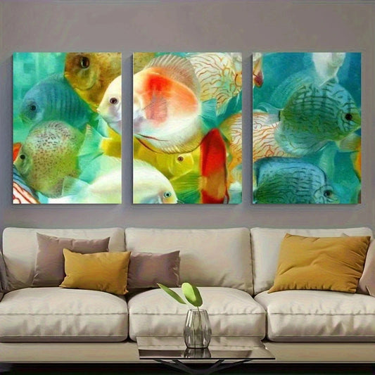 Three colorful fish paintings on a wall above a beige sofa with yellow and brown cushions.