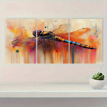 Triptych painting of a dragonfly on a wall above a shelf with a plant.