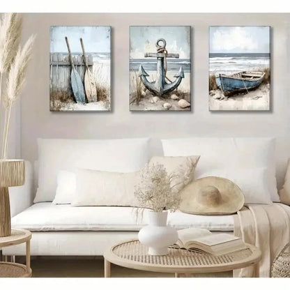 Three coastal-themed wall art pieces above a white sofa in a living room.