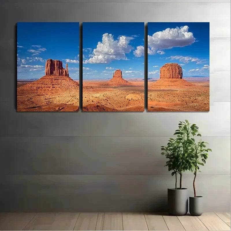 Three-panel canvas print of a desert landscape with rock formations on a gray wall.