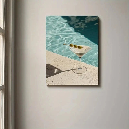 Canvas print of a cocktail with olives by a pool on a wall.