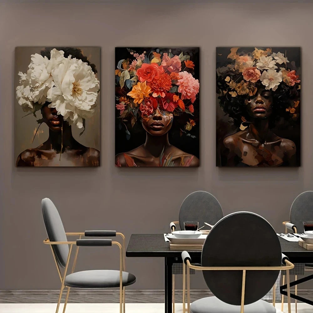Dining room with three artistic wall hangings of women with floral heads on a gray wall.