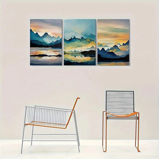 Three-panel wall art of a mountain landscape with two chairs below.