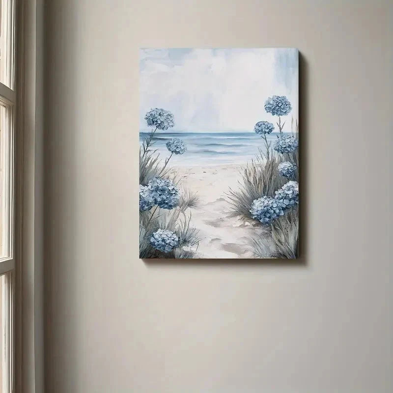 Canvas print of a beach scene with blue flowers hanging on a wall.