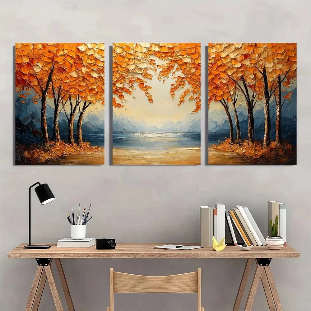 Three-panel painting of autumn trees over a lake on a wall above a desk.