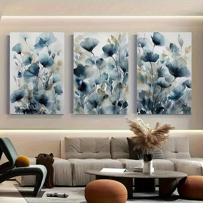 Three floral wall art pieces above a sofa in a living room.