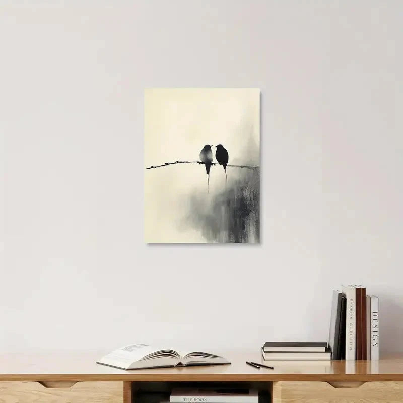 Two birds on a wire painting above a wooden shelf with books and an open book.