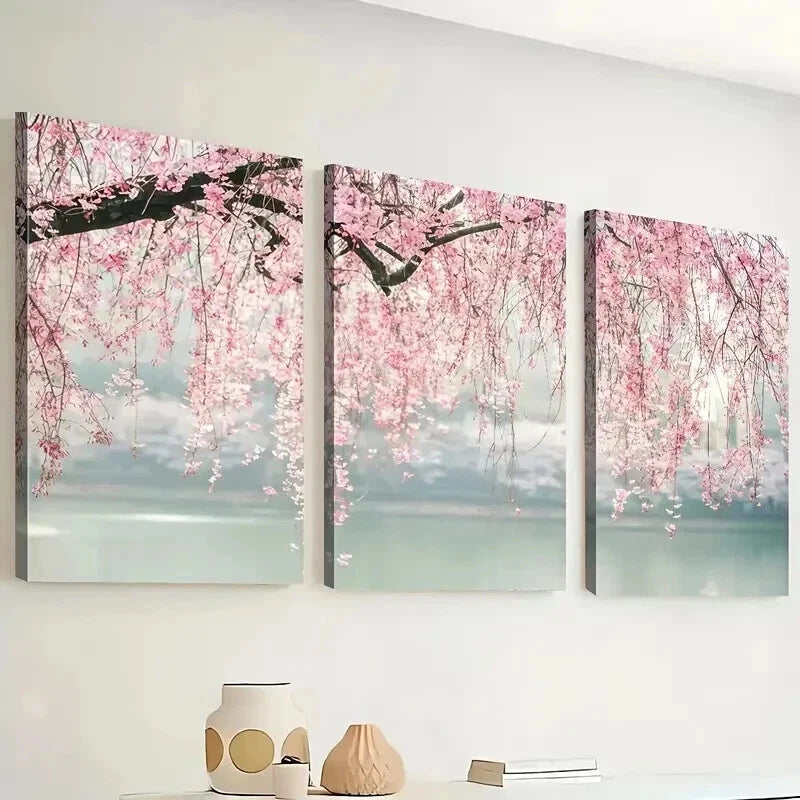 Three panels of cherry blossom art on a wall with decorative vases below.