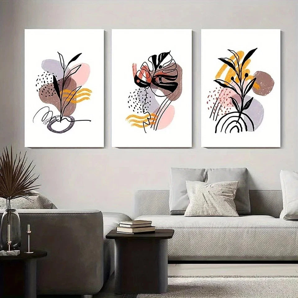 Three abstract art prints on a wall above a sofa in a living room.