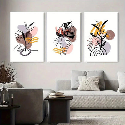 Three abstract art prints on a wall above a sofa in a living room.