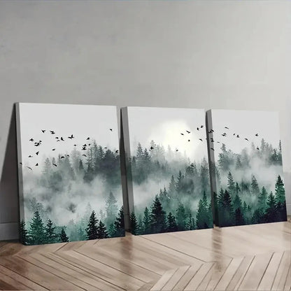 Three canvas prints of a forest scene with trees and birds on a wooden floor.