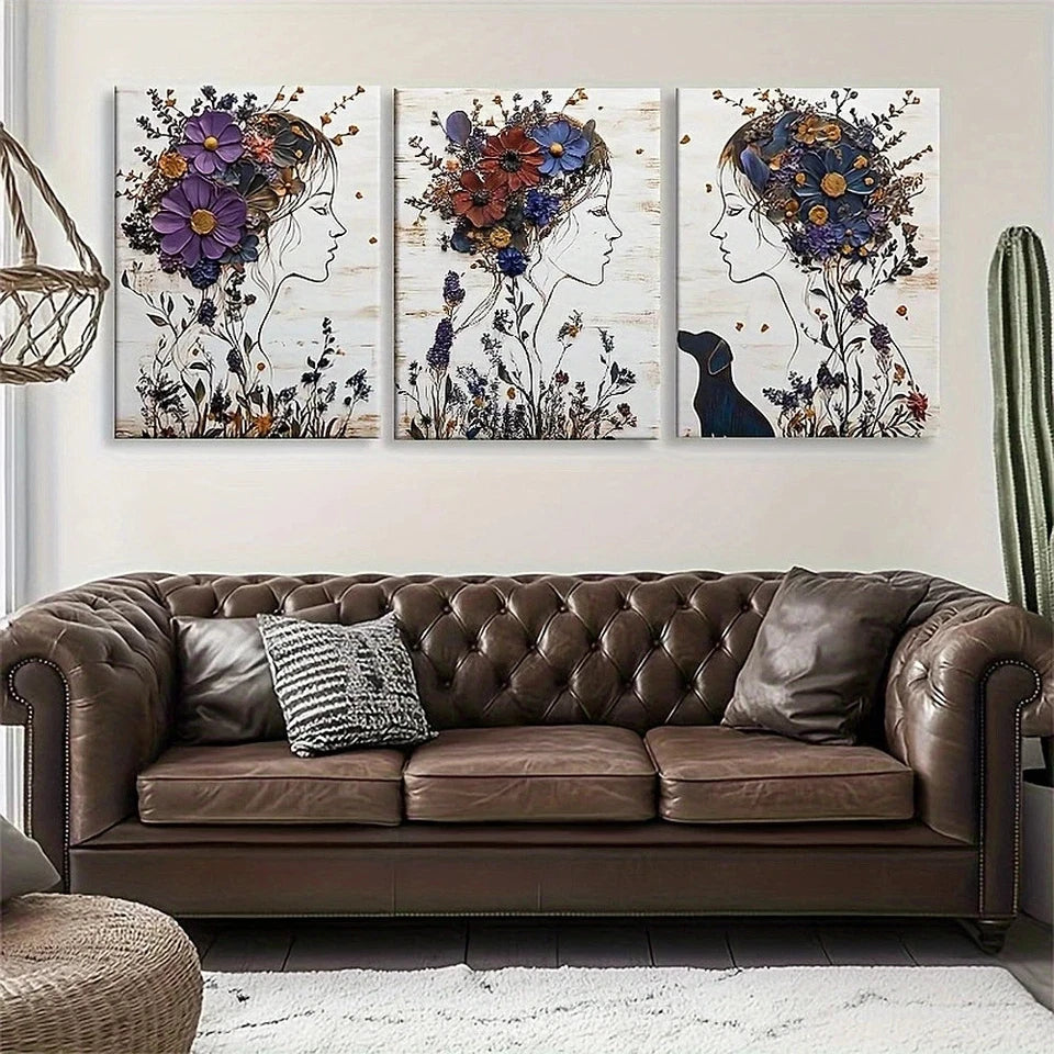 Three floral art pieces above a brown leather sofa in a living room setting.